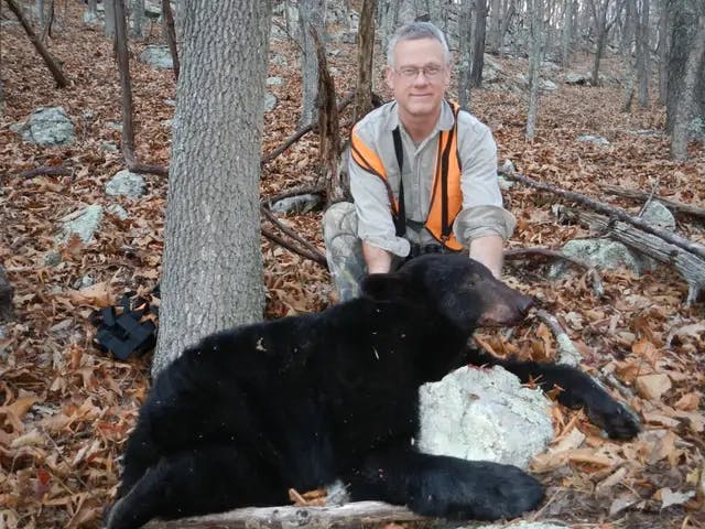 Steve next to a bear he shot